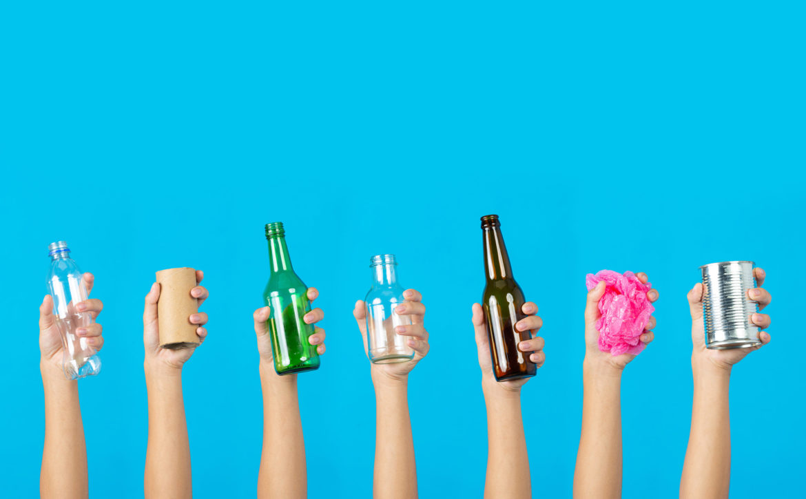 many hands holding many kind of garbage on blue background